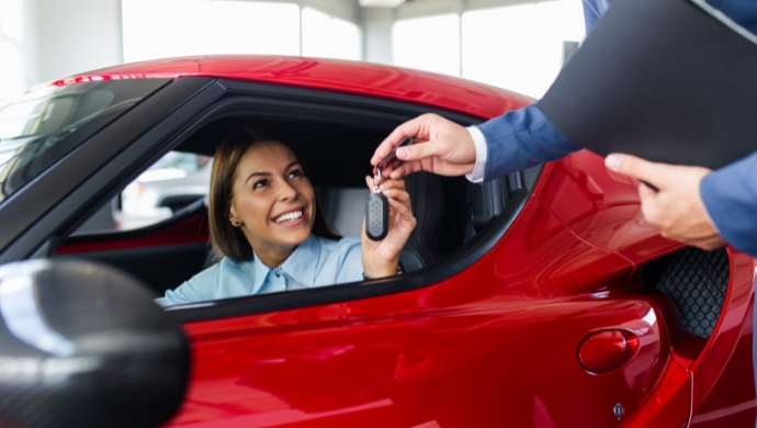 man in a car receiving key